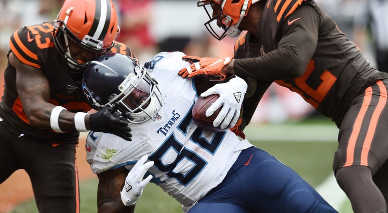 Sep 8, 2019; Cleveland, OH, USA; Tennessee Titans tight end Delanie Walker (82) scores a touchdown as Cleveland Browns strong safety Damarious Randall (23) and strong safety Morgan Burnett (42) defend during the second half at FirstEnergy Stadium. Tennessee Titans tight end Delanie Walker (82) scores a touchdown as Cleveland Browns strong safety Damarious Randall (23) and strong safety Morgan Burnett (42) defend