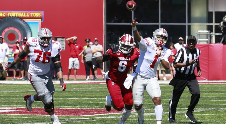 Ohio State Buckeyes quarterback Justin Fields (1) throws a pass against the Indiana Hoosiers during the second quarter at Memorial Stadium . Ohio State Buckeyes quarterback Justin Fields (1) throws a pass against the Indiana Hoosiers during the second quarter at Memorial Stadium .
