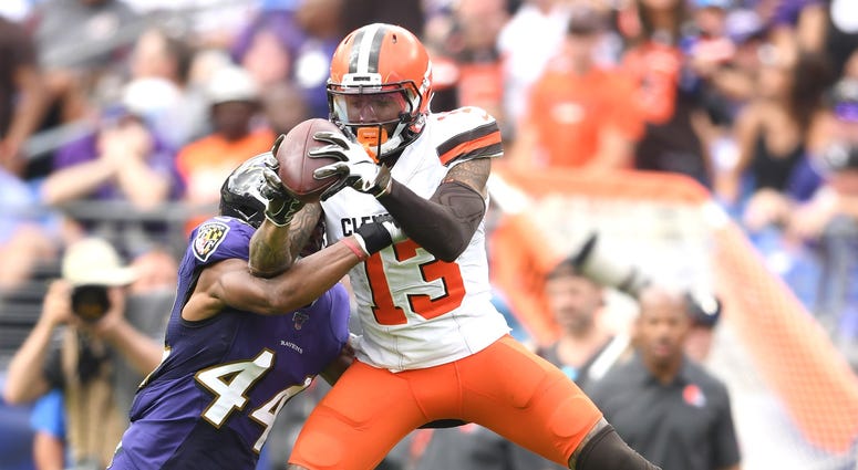 Cleveland Browns wide receiver Odell Beckham (13) ties to catch a pass with pressure form Baltimore Ravens cornerback Marlon Humphrey (44) in the forth quarter in a football game against the Cleveland Browns at M&T Bank Stadium