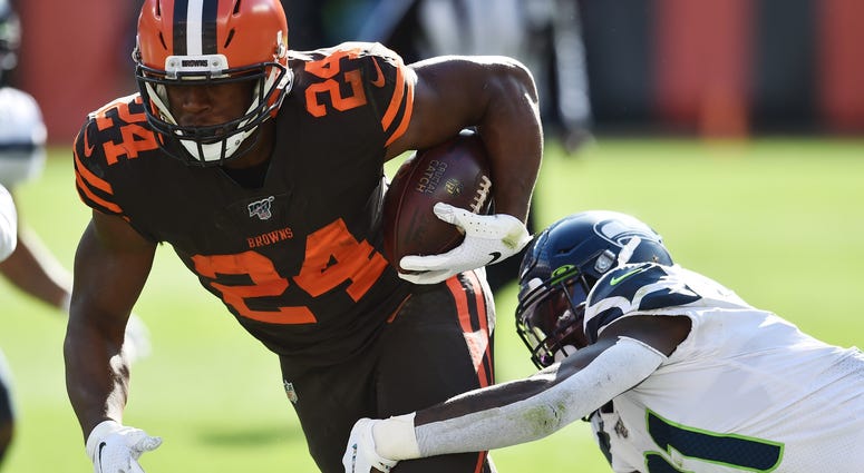 Oct 13, 2019; Cleveland, OH, USA; Cleveland Browns running back Nick Chubb (24) runs with the ball as Seattle Seahawks cornerback Tre Flowers (21) defends during the second half at FirstEnergy Stadium. Mandatory Credit: Ken Blaze-USA TODAY Sports