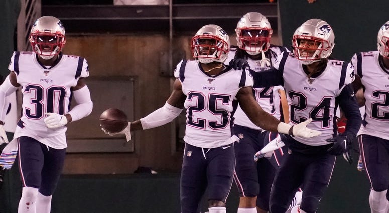 East Rutherford, NJ, USA; New England Patriots defensive back Terrence Brooks (25) after intercepting a pass by the Jets in the second half at MetLife Stadium. Mandatory Credit: Robert Deutsch-USA TODAY Sports