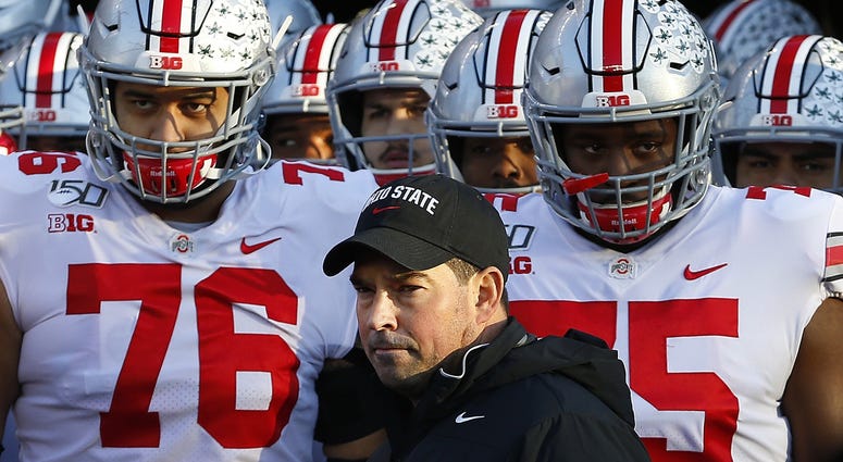 Ohio State Buckeyes head coach Ryan Day stands with players before a game against the Rutgers Scarlet Knights at SHI Stadium. Ohio State Buckeyes head coach Ryan Day stands with players before a game against the Rutgers Scarlet Knights at SHI Stadium.