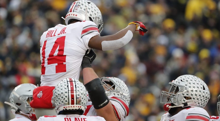 Ohio State Buckeyes wide receiver K.J. Hill (14) is congratulated by teammates after he scores a touchdown in the second half against the Michigan Wolverines at Michigan Stadium. Ohio State Buckeyes wide receiver K.J. Hill (14) is congratulated by teammates after he scores a touchdown in the second half against the Michigan Wolverines at Michigan Stadium.