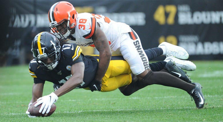 Pittsburgh Steelers wide receiver Deon Cain (17) picks up yards as the Cleveland Browns cornerback TJ Carrie (38) makes the stop during the second quarter at Heinz Field. TJ Carrie Cleveland Browns