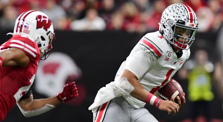Dec 7, 2019; Indianapolis, IN, USA; Ohio State Buckeyes quarterback Justin Fields (1) runs out of the pocket against the Wisconsin Badgers during the first half in the 2019 Big Ten Championship Game at Lucas Oil Stadium. Ohio State quarterback Justin Fields