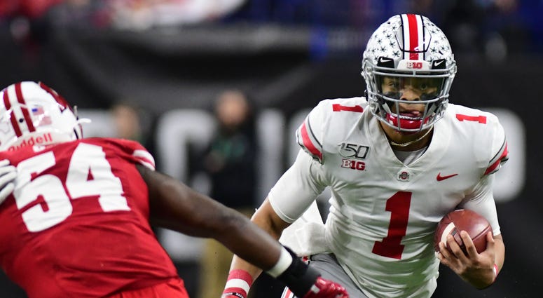 Dec 7, 2019; Indianapolis, IN, USA; Ohio State Buckeyes quarterback Justin Fields (1) runs out of the pocket against the Wisconsin Badgers during the first half in the 2019 Big Ten Championship Game at Lucas Oil Stadium. Ohio State quarterback Justin Fields