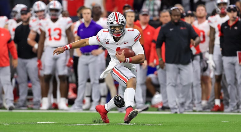 Dec 7, 2019; Indianapolis, IN, USA; Ohio State Buckeyes quarterback Justin Fields (1) carries the ball against the Wisconsin Badgers during the first half in the 2019 Big Ten Championship Game at Lucas Oil Stadium. Mandatory Credit: Aaron Doster-USA TODAY Dec 7, 2019; Indianapolis, IN, USA; Ohio State Buckeyes quarterback Justin Fields (1) carries the ball against the Wisconsin Badgers during the first half in the 2019 Big Ten Championship Game at Lucas Oil Stadium. Mandatory Credit: Aaron Doster-USA TODAY
