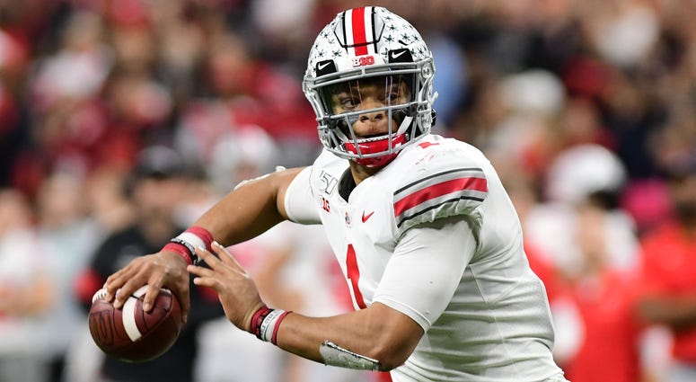 Ohio State quarterback Justin Fields (1) rolls out of the pocket to throw for a touchdown in the second half against the Wisconsin Badgers in the 2019 Big Ten Championship Game at Lucas Oil Stadium. Ohio State quarterback Justin Fields (1) rolls out of the pocket to throw for a touchdown in the second half against the Wisconsin Badgers in the 2019 Big Ten Championship Game at Lucas Oil Stadium.