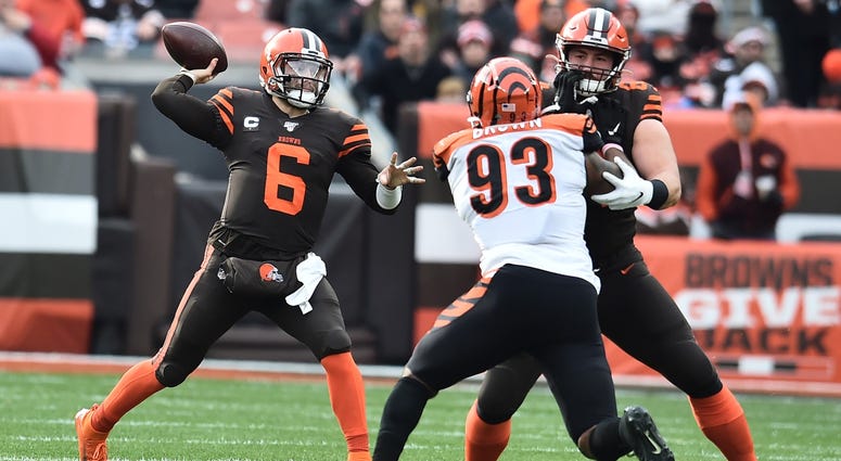 Cleveland Browns quarterback Baker Mayfield (6) throws a pass as center JC Tretter (64) blocks Cincinnati Bengals defensive tackle Andrew Brown (93) during the first half at FirstEnergy Stadium. Cleveland Browns quarterback Baker Mayfield (6) throws a pass as center JC Tretter (64) blocks Cincinnati Bengals defensive tackle Andrew Brown (93) during the first half at FirstEnergy Stadium.
