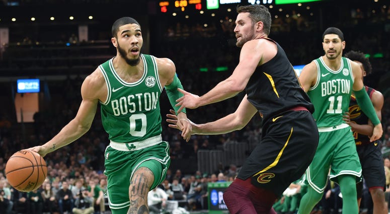 Dec 27, 2019; Boston, Massachusetts, USA; Boston Celtics forward Jayson Tatum (0) drives to the basket while Cleveland Cavaliers forward Kevin Love (0) defends during the first half at TD Garden. Boston Celtics forward Jayson Tatum (0) drives to the basket while Cleveland Cavaliers forward Kevin Love (0) defends