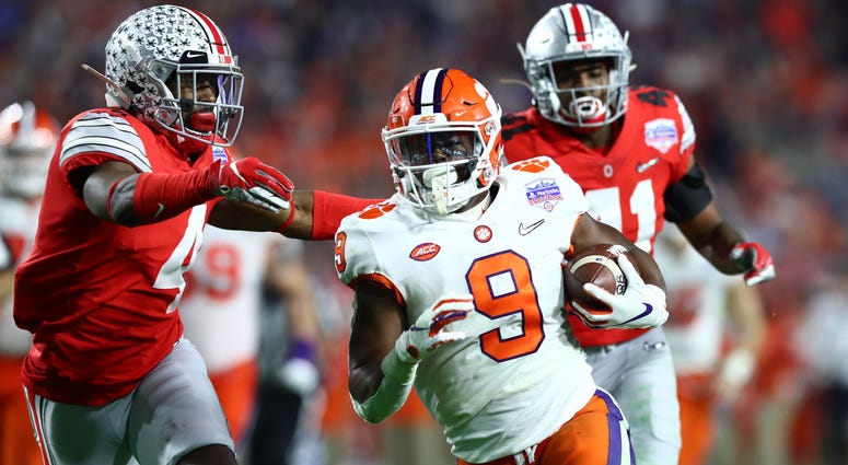 Dec 28, 2019; Glendale, AZ, USA; Clemson Tigers running back Travis Etienne (9) scores a touchdown against the Ohio State Buckeyes during the fourth quarter in the 2019 Fiesta Bowl college football playoff semifinal game at State Farm Stadium. Dec 28, 2019; Glendale, AZ, USA; Clemson Tigers running back Travis Etienne (9) scores a touchdown against the Ohio State Buckeyes during the fourth quarter in the 2019 Fiesta Bowl college football playoff semifinal game at State Farm Stadium. Mandatory C