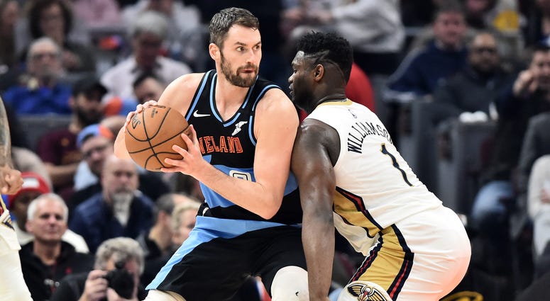 Jan 28, 2020; Cleveland, Ohio, USA; New Orleans Pelicans forward Zion Williamson (1) guards Cleveland Cavaliers forward Kevin Love (0) during the first half at Rocket Mortgage FieldHouse. Mandatory Credit: Ken Blaze-USA TODAY Sports