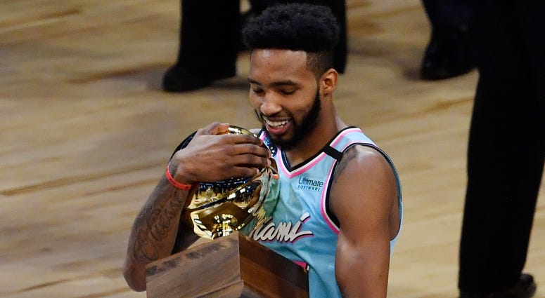 Feb 15, 2020; Chicago, Illinois, USA; Miami Heat player Derrick Jones, Jr. celebrates with the trophy after winning the slam dunk contest during NBA All Star Saturday Night at United Center. Miami Heat player Derrick Jones Jr.