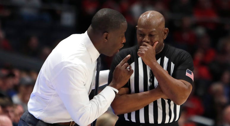 Feb 22, 2020; Dayton, Ohio, USA; Dayton Flyers head coach Anthony Grant (left) talks to a referee during the second half against the Duquesne Dukes at University of Dayton Arena. Mandatory Credit: David Kohl-USA TODAY Sports