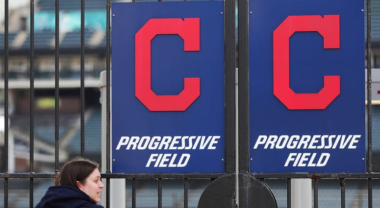 Mar 26, 2020; Akron, OH, USA; Cleveland Indians fan Melissa Dallachiesa of Cleveland leans on the left field gate outside Progressive Field in Cleveland, Ohio. The Indians were scheduled to play the Detroit Tigers, but the season has been delayed due to t