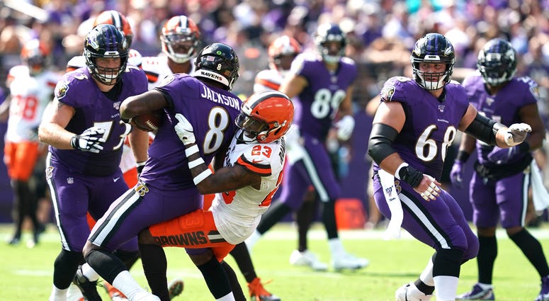 Browns safety Damarious Randall tackles Ravens quarterback Lamar Jackson