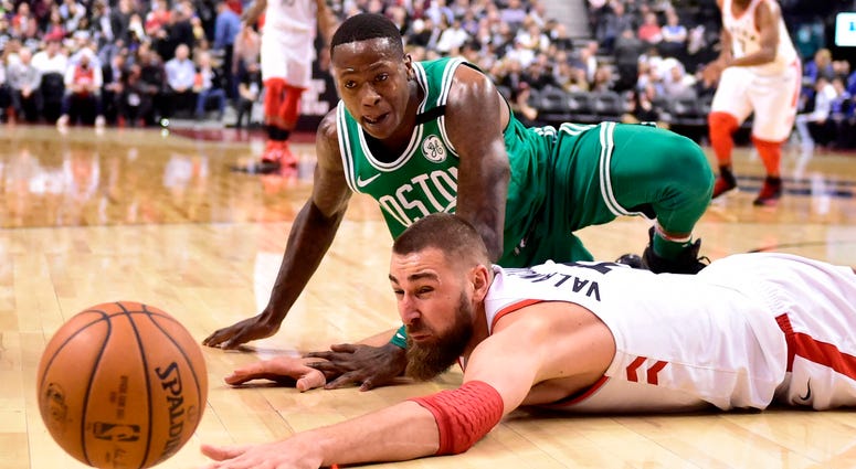 Toronto Raptors center Jonas Valanciunas and Boston Celtics guard Terry Rozier watch the ball get away during the second half of an NBA basketball game Wednesday, April 4, 2018, in Toronto. (Frank Gunn/The Canadian Press via AP) Toronto Raptors center Jonas Valanciunas and Boston Celtics guard Terry Rozier watch the ball get away during the second half of an NBA basketball game Wednesday, April 4, 2018, in Toronto. (Frank Gunn/The Canadian Press via AP)