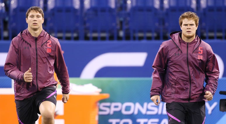 Mar 3, 2018; Indianapolis, IN, USA; From left to right Wyoming Cowboys quarterback Josh Allen and USC Trojans quarterback Sam Darnold warm up during the 2018 NFL Combine at Lucas Oil Stadium. Mandatory Credit: Brian Spurlock-USA TODAY Sports