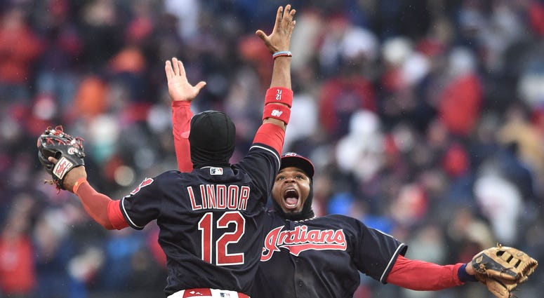 Cleveland Indians shortstop Francisco Lindor (12) and center fielder Rajai Davis (26) celebrate after defeating the Kansas City Royals at Progressive Field. Cleveland Indians shortstop Francisco Lindor (12) and center fielder Rajai Davis (26) celebrate after defeating the Kansas City Royals at Progressive Field.