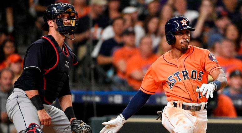 Houston Astros' Tony Kemp watches his two-run double in front of Cleveland Indians catcher Yan Gomes during the seventh inning of a baseball game Friday, May 18, 2018, in Houston. Houston Astros' Tony Kemp watches his two-run double in front of Cleveland Indians catcher Yan Gomes during the seventh inning of a baseball game Friday, May 18, 2018, in Houston.