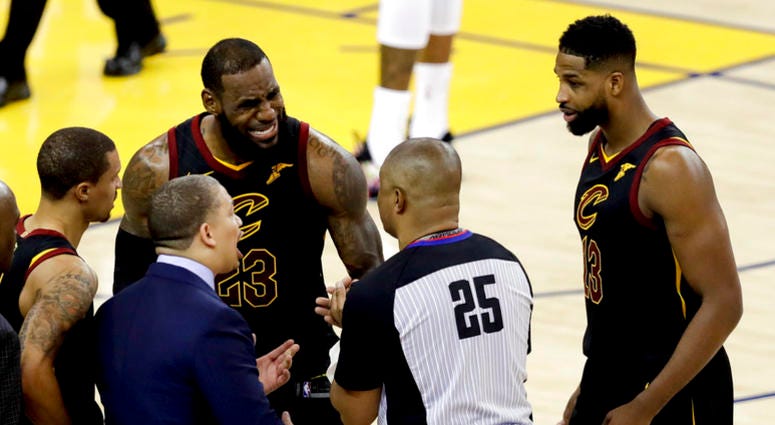 Cleveland Cavaliers forward LeBron James (23) and head coach Tyronn Lue, bottom, talk with referee Tony Brothers (25) during the second half of Game 1 of basketball's NBA Finals against the Golden State Warriors in Oakland, Calif., Thursday, May 31, 2018. Cleveland Cavaliers forward LeBron James (23) and head coach Tyronn Lue, bottom, talk with referee Tony Brothers (25) during the second half of Game 1 of basketball's NBA Finals against the Golden State Warriors in Oakland, Calif., Thursday, May 31, 2018.