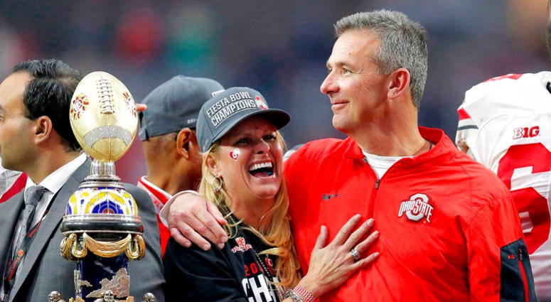 Ohio State head coach Urban Meyer hugs his wife, Shelley, after their 44-28 win over Notre Dame in the Fiesta Bowl NCAA college football game, in Glendale, Ariz. Ohio State placed Meyer on paid administrative leave Wednesday, Aug. 1, 2018, while it invest Ohio State head coach Urban Meyer hugs his wife, Shelley, after their 44-28 win over Notre Dame in the Fiesta Bowl NCAA college football game, in Glendale, Ariz. Ohio State placed Meyer on paid administrative leave Wednesday, Aug. 1, 2018, while it invest