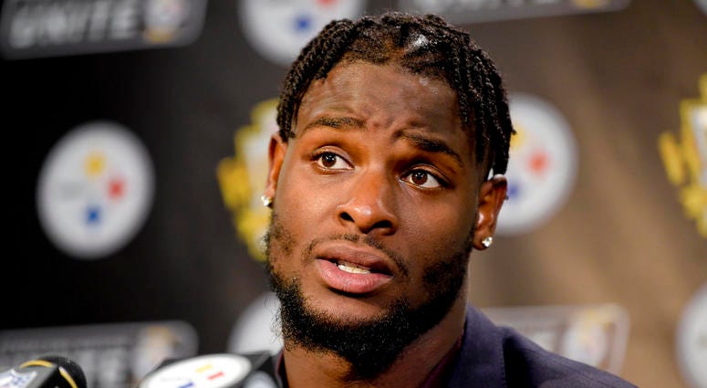 FILE - In this Oct. 22, 2017, file photo, Pittsburgh Steelers running back Le'Veon Bell (26) answers questions at a post-game meeting with reporters following a 29-14 win over the Cincinnati Bengals in an NFL football game in Pittsburgh. The Steelers are beginning preparations for their Week 1 opener against Cleveland without All-Pro running back Le'Veon Bell. Bell did not arrive at the team's facility in time for practice on Monday nd has yet to sign his one-year franchise tender.