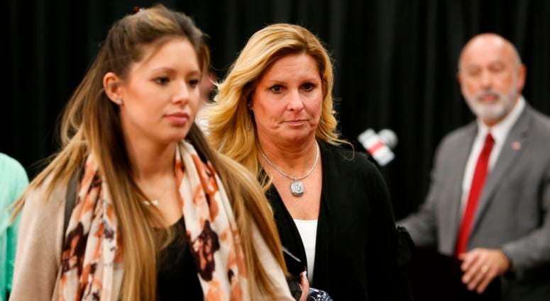 Shelley Meyer, center, wife of Ohio State NCAA college football head coach Urban Meyer, walks into a news conference where Urban Meyer announced his retirement Tuesday, Dec. 4, 2018, in Columbus, Ohio. Shelley Meyer, center, wife of Ohio State NCAA college football head coach Urban Meyer, walks into a news conference where Urban Meyer announced his retirement Tuesday, Dec. 4, 2018, in Columbus, Ohio.