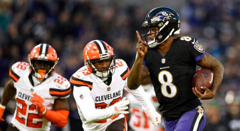 Baltimore Ravens quarterback Lamar Jackson, right, rushes for a touchdown past Cleveland Browns free safety Jabrill Peppers, back left, and strong safety Damarious Randall in the first half of an NFL football game, Sunday, Dec. 30, 2018, in Baltimore. (AP Baltimore Ravens quarterback Lamar Jackson, right, rushes for a touchdown past Cleveland Browns free safety Jabrill Peppers, back left, and strong safety Damarious Randall in the first half of an NFL football game, Sunday, Dec. 30, 2018, in Baltimore. (AP
