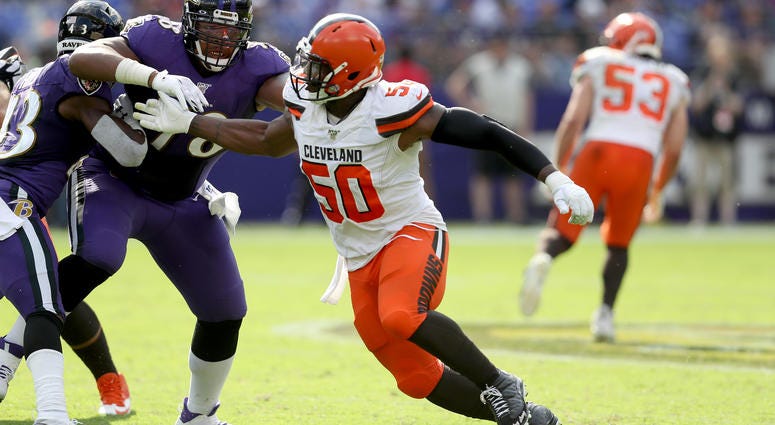 Orlando Brown #78 of the Baltimore Ravens blocks Chris Smith #50 of the Cleveland Browns at M&T Bank Stadium on September 29, 2019 in Baltimore, Maryland. Chris Smith Cleveland Browns