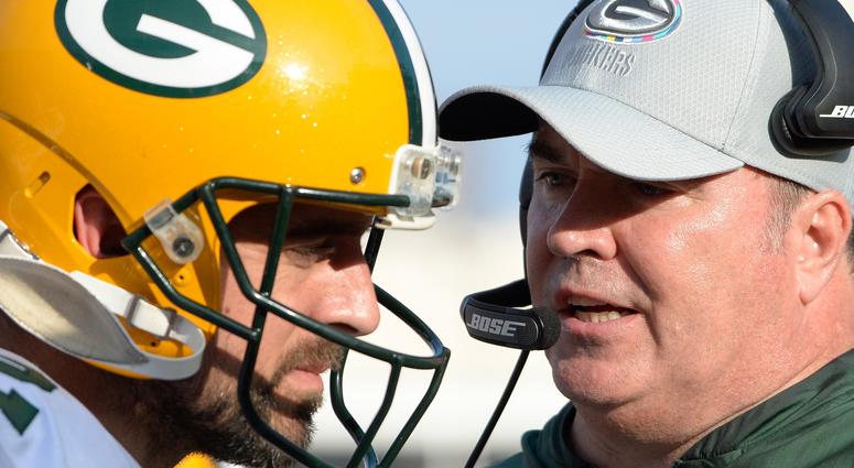 Green Bay Packers head coach Mike McCarthy (right) talks to quarterback Aaron Rodgers (12) during the second half against the Los Angeles Rams at Los Angeles Memorial Coliseum.
