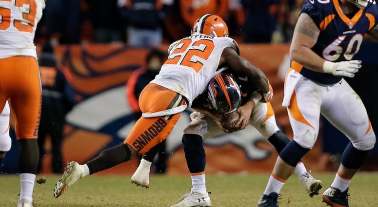 Cleveland Browns defensive back Jabrill Peppers (22) sacks Denver Broncos quarterback Case Keenum (4) as offensive guard Connor McGovern (60) defends in the fourth quarter at Broncos Stadium at Mile High.