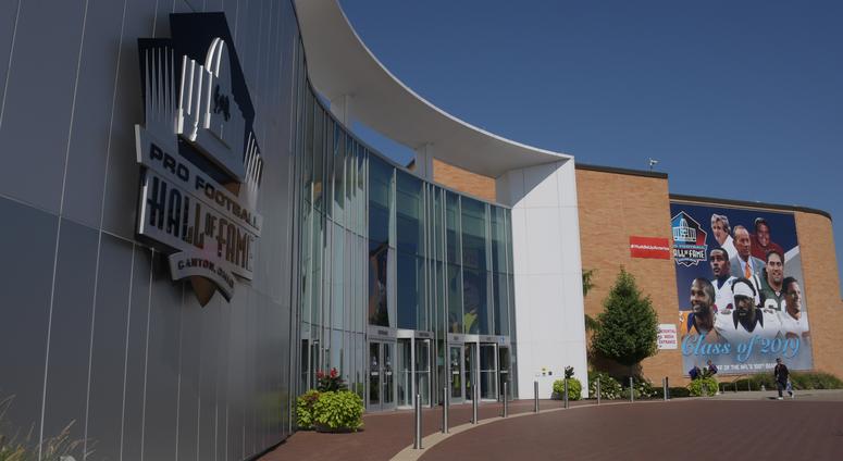 A banner featuring 2019 inductees Champ Bailey and Pat Bowlen and Gil Brandt and Tony Gonzalez and Ty Law and Kevin Mawae and Ed Reed and Johnny Robinson hangs outside the Pro Football Hall of Fame. A banner featuring 2019 inductees Champ Bailey and Pat Bowlen and Gil Brandt and Tony Gonzalez and Ty Law and Kevin Mawae and Ed Reed and Johnny Robinson hangs outside the Pro Football Hall of Fame.