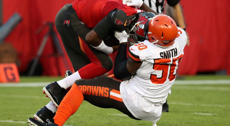 Aug 23, 2019; Tampa, FL, USA; Cleveland Browns defensive end Chris Smith (50) sacks Tampa Bay Buccaneers quarterback Jameis Winston (3) during the first quarter at Raymond James Stadium.