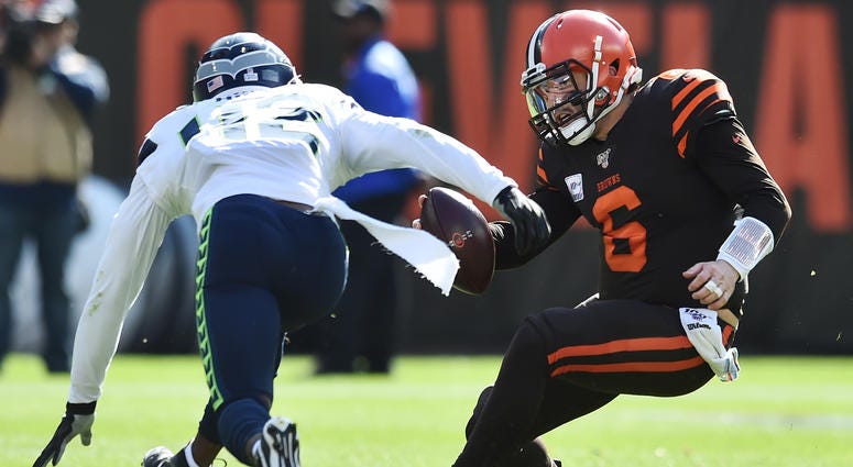 Seattle Seahawks defensive back Lano Hill (42) charges Cleveland Browns quarterback Baker Mayfield (6) during the second half at FirstEnergy Stadium. Baker Mayfield