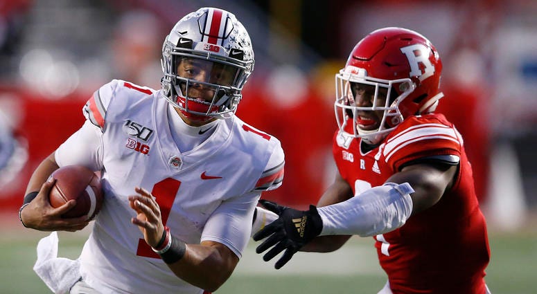 Ohio State Buckeyes quarterback Justin Fields (1) runs the ball against Rutgers Scarlet Knights defensive lineman Elorm Lumor (7) Ohio State Buckeyes quarterback Justin Fields (1) runs the ball against Rutgers Scarlet Knights defensive lineman Elorm Lumor (7)