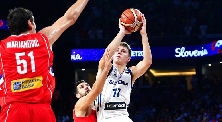 FILE - In this Sept. 17, 2017, file photo, Slovenia's Luka Doncic, right, shoots a basket as Serbia's Vasilje Micic tries to stop him during their Eurobasket European Basketball Championship final match in Istanbul. FILE - In this Sept. 17, 2017, file photo, Slovenia's Luka Doncic, right, shoots a basket as Serbia's Vasilje Micic tries to stop him during their Eurobasket European Basketball Championship final match in Istanbul.