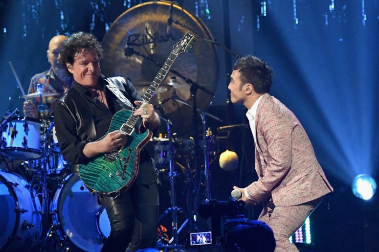 Neal Schon and Arnel Pineda of Journey perform onstage at the 32nd Annual Rock & Roll Hall Of Fame Induction Ceremony Neal Schon and Arnel Pineda of Journey perform onstage at the 32nd Annual Rock & Roll Hall Of Fame Induction Ceremony