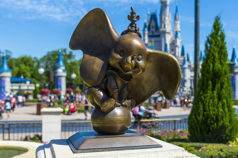 Dumbo statue at walt disney world magic kingdomorlando florida with Cinderella Princess castle Dumbo statue at walt disney world magic kingdomorlando florida with Cinderella Princess castle