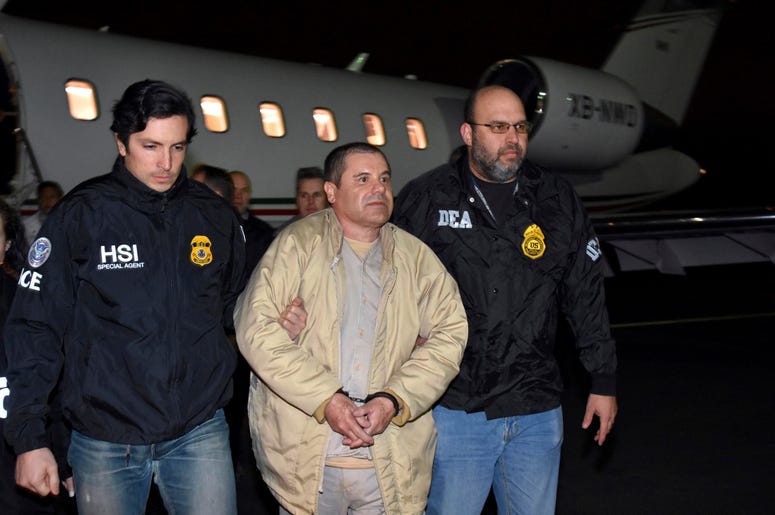 En esta foto de archivo del 19 de enero de 2017 distribuida por la policía, agentes escoltan al narco mexicano Joaquín "El Chapo" Guzmán, centro, de un avión a una caravana de camionetas en el el aeropuerto MacArthur de Ronkonkoma, Nueva York En esta foto de archivo del 19 de enero de 2017 distribuida por la policía, agentes escoltan al narco mexicano Joaquín "El Chapo" Guzmán, centro, de un avión a una caravana de camionetas en el el aeropuerto MacArthur de Ronkonkoma, Nueva York