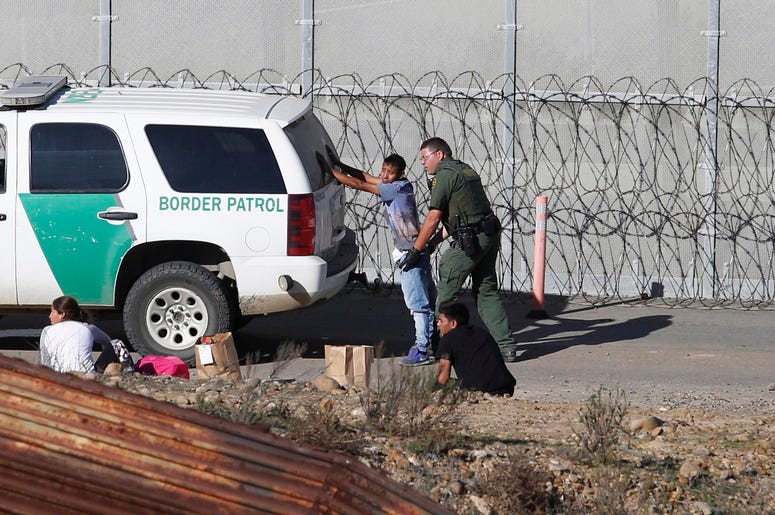 En esta fotograf a del 15 de diciembre de 2018, unos solicitantes de asilo hondure os son detenidos por los agentes de la Patrulla Fronteriza de Estados Unidos, tras cruzar el muro fronterizo de Tijuana, M xico, a San Diego, California. En esta fotograf a del 15 de diciembre de 2018, unos solicitantes de asilo hondure os son detenidos por los agentes de la Patrulla Fronteriza de Estados Unidos, tras cruzar el muro fronterizo de Tijuana, M xico, a San Diego, California.