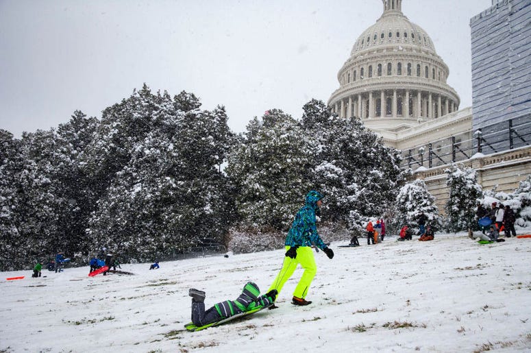 WASHINGTON, DC - JANUARY 13: A man pulls his son up the hill as people sled on the west side of the U.S. Capitol, on January 13, 2019 in Washington, DC. The DC area was hit with 4-7 inches of snow accumulation with the potential of another 2-4 inches. WASHINGTON, DC - JANUARY 13: A man pulls his son up the hill as people sled on the west side of the U.S. Capitol, on January 13, 2019 in Washington, DC. The DC area was hit with 4-7 inches of snow accumulation with the potential of another 2-4 inches.