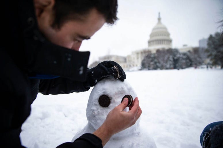 WASHINGTON, DC - JANUARY 13: Ivan Lopez, from Columbia, MD, uses Oreos to make eyes for his snowman, on the west side of the U.S. Capitol, on January 13, 2019 in Washington, DC. WASHINGTON, DC - JANUARY 13: Ivan Lopez, from Columbia, MD, uses Oreos to make eyes for his snowman, on the west side of the U.S. Capitol, on January 13, 2019 in Washington, DC.