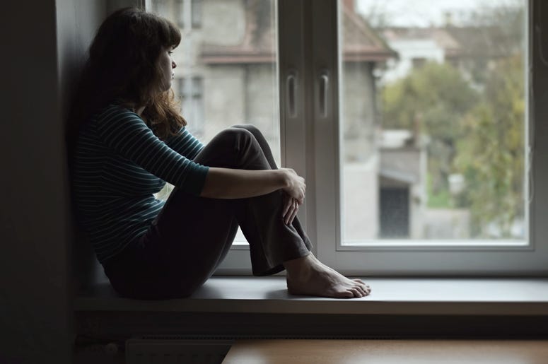 Anxious woman looks out of the window Anxious woman looks out of the window