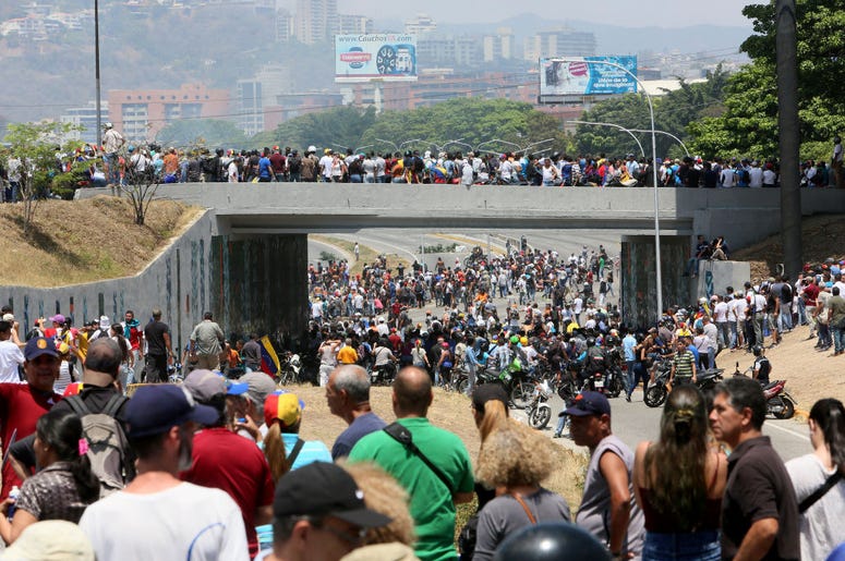 Demonstrators gather near La Carlota air force on April 30, 2019 in Caracas, Venezuela. Through a live broadcast via social media, Venezuelan opposition leader Juan Guaido called for a military uprising against the government of Nicolás Maduro. He declare Demonstrators gather near La Carlota air force on April 30, 2019 in Caracas, Venezuela. Through a live broadcast via social media, Venezuelan opposition leader Juan Guaido called for a military uprising against the government of Nicolás Maduro. He declare