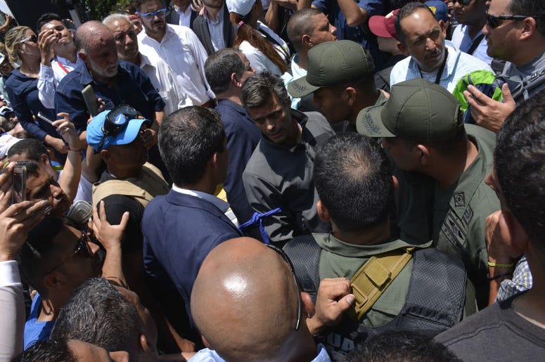 Venezuelan opposition leader Juan Guaidó, recognized by many members of the international community as the country's rightful interim ruler, speaks to opposition activist Leopoldo Lopez as they walk among supporters on April 30, 2019 in Caracas, Venezuela Venezuelan opposition leader Juan Guaidó, recognized by many members of the international community as the country's rightful interim ruler, speaks to opposition activist Leopoldo Lopez as they walk among supporters on April 30, 2019 in Caracas, Venezuela
