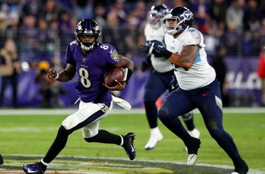 Quarterback Lamar Jackson #8 of the Baltimore Ravens carries the ball against the defense of the Tennessee Titans during the AFC Divisional Playoff game at M&T Bank Stadium on January 11, 2020 in Baltimore, Maryland