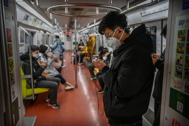 A Chinese man wears a protective mask as he stands on the subway during rush hour on February 17, 2020 in Beijing, China. A Chinese man wears a protective mask as he stands on the subway during rush hour on February 17, 2020 in Beijing, China.