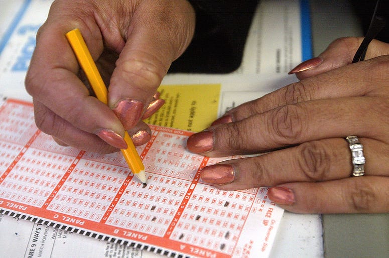 A lottery player selects her numbers on a Powerball ticket at a Citgo gas station December 30, 2003 in Pleasant Prairie, Wisconsin. Since no one matched Powerball's six winning numbers on December 27, the next drawing on New Year's Eve has risen the jackp A lottery player selects her numbers on a Powerball ticket at a Citgo gas station December 30, 2003 in Pleasant Prairie, Wisconsin. Since no one matched Powerball's six winning numbers on December 27, the next drawing on New Year's Eve has risen the jackp