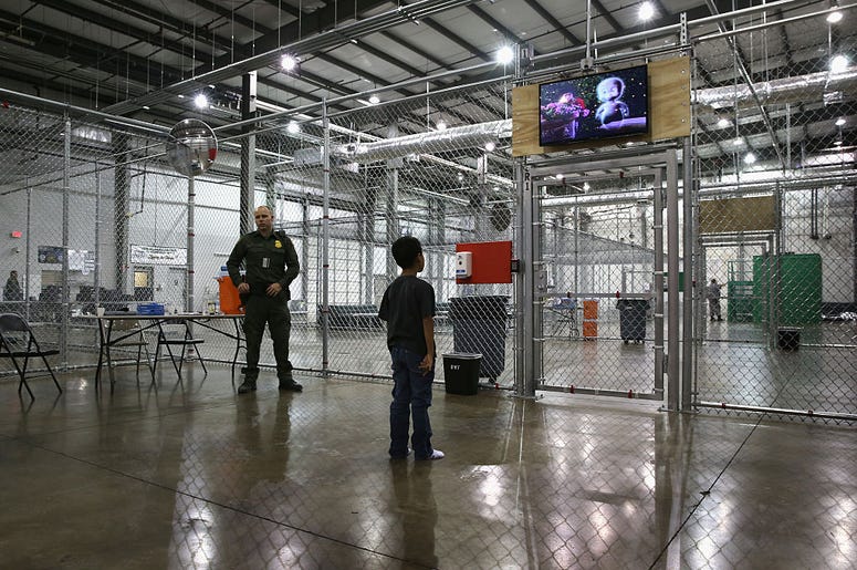 A boy from Honduras watches a movie at a detention facility run by the U.S. Border Patrol on September 8, 2014 in McAllen, Texas. The Border Patrol opened the holding center to temporarily house the children after tens of thousands of families and unaccom A boy from Honduras watches a movie at a detention facility run by the U.S. Border Patrol on September 8, 2014 in McAllen, Texas. The Border Patrol opened the holding center to temporarily house the children after tens of thousands of families and unaccom